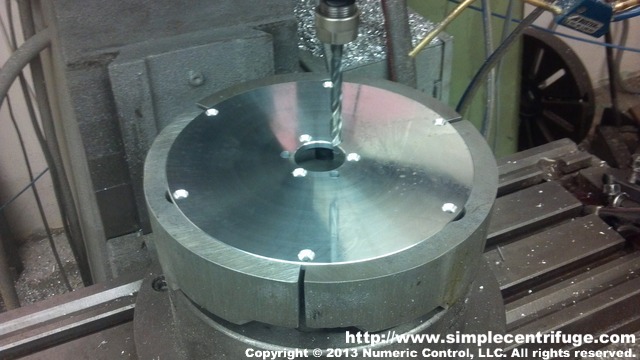 Lid is drilled on CNC mill. Pie jaws ensure repeatability across all parts. Next it will be deburred by hand.