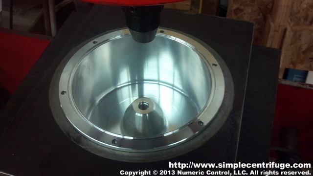 Captive nuts have been pressed in using custom fixture.