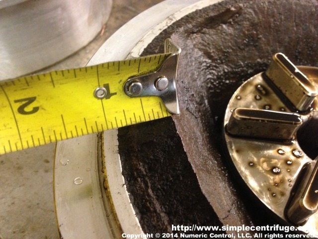 The particulate accumulated unequally. We have seen this before with high amounts of water and particulate. Normally we would have cleaned the rotor before allowing it to build up so thick. Machine was running smooth despite the unequal thickness.