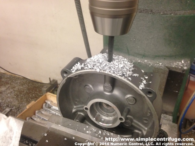 The dimensions are not super critical. I set this up by eye. You want to be in the center of the cast boss. There is a mark on this endbell that will help you locate center. To ensure the boss is perpendicular to the vise I measured up to the bearing retainer bolt holes.