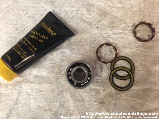 Preparing to repack a seal bearing for high speed operation. The factory grease which was barely any, was washed out with solvent after removing the seals and ball retainers. The grease being used will be Kluber Isoflex NBU-15.