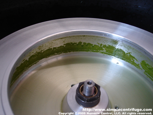 Once the bowl stops you can see the algae cake that has formed. This cake would then be dried and pressed for oil.