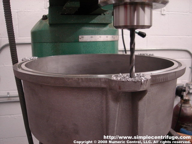 Drilling the centrifuge body casting for the lid studs.