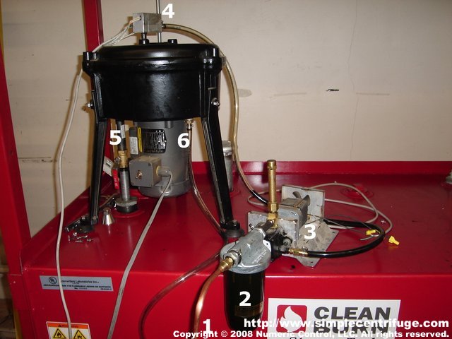 This is a picture of our prototype system.
1) Infeed suction line.
2) Goldrod filter housing with 100 mesh screen filter.
3) Gear motor driven oil pump.
4) 500 watt inline oil heater.
5) Main drain into finish tank.
6) Sump drain.