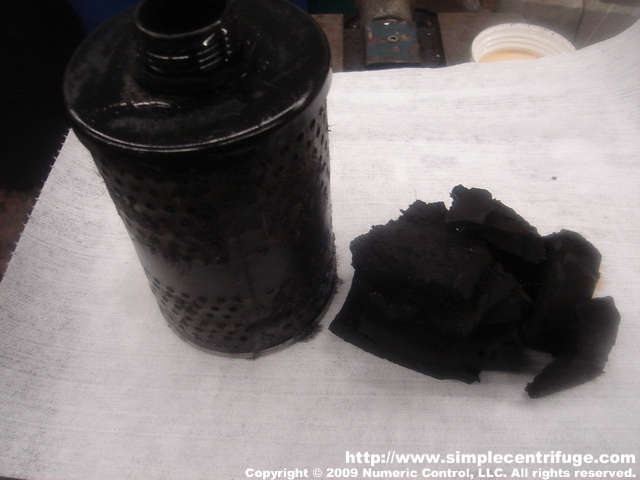 This is some of the carbons and dirt captured from 15 gallons of waster motor oil. The oil passed through the 10 micron filter on the left ahead of my feed pump. The carbons formed a very dry cake inside the centrifuge.