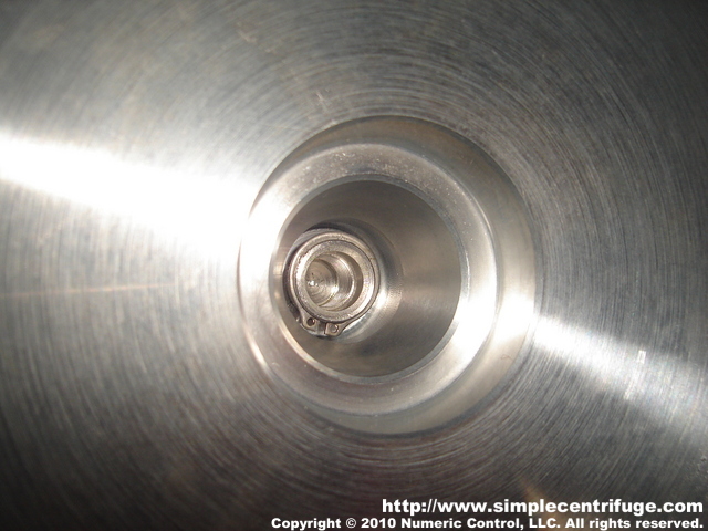 This photo shows the bottom of the nut which is retained by a clip. You can also see the taper.