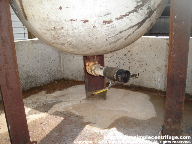 This shows the bottom drain and cam lock connector. This allows the waste water to be drained into a tank for disposal.