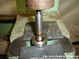 Using a press you can remove the upper bearing.
