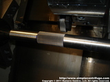 Knurled the shaft. The knurling will hold the core in place.