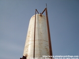 Used motor oil is first pumped into the 1000 gallon vertical settling tank. This allows the majority of the water to be settled off. The three pipes shown in this photo, from left to right, are air bleed/over fill, fill pipe (larger), and heater vent.