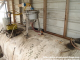 Yellow line is incoming hot oil from the heater. Red hose is the clean oil going to the 3000 gallon storage tank. The white hose is the inner sump drain which is directed to a bucket. This drains off any small amount of oil that may collect around the motor shaft. Note that the motor is dry. Copper lines leaving thank feed a furnace.